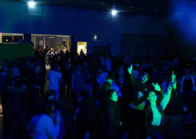 Vue d’ensemble d’une soirée dansante avec un public nombreux, éclairages d’ambiance et piste de danse animée.